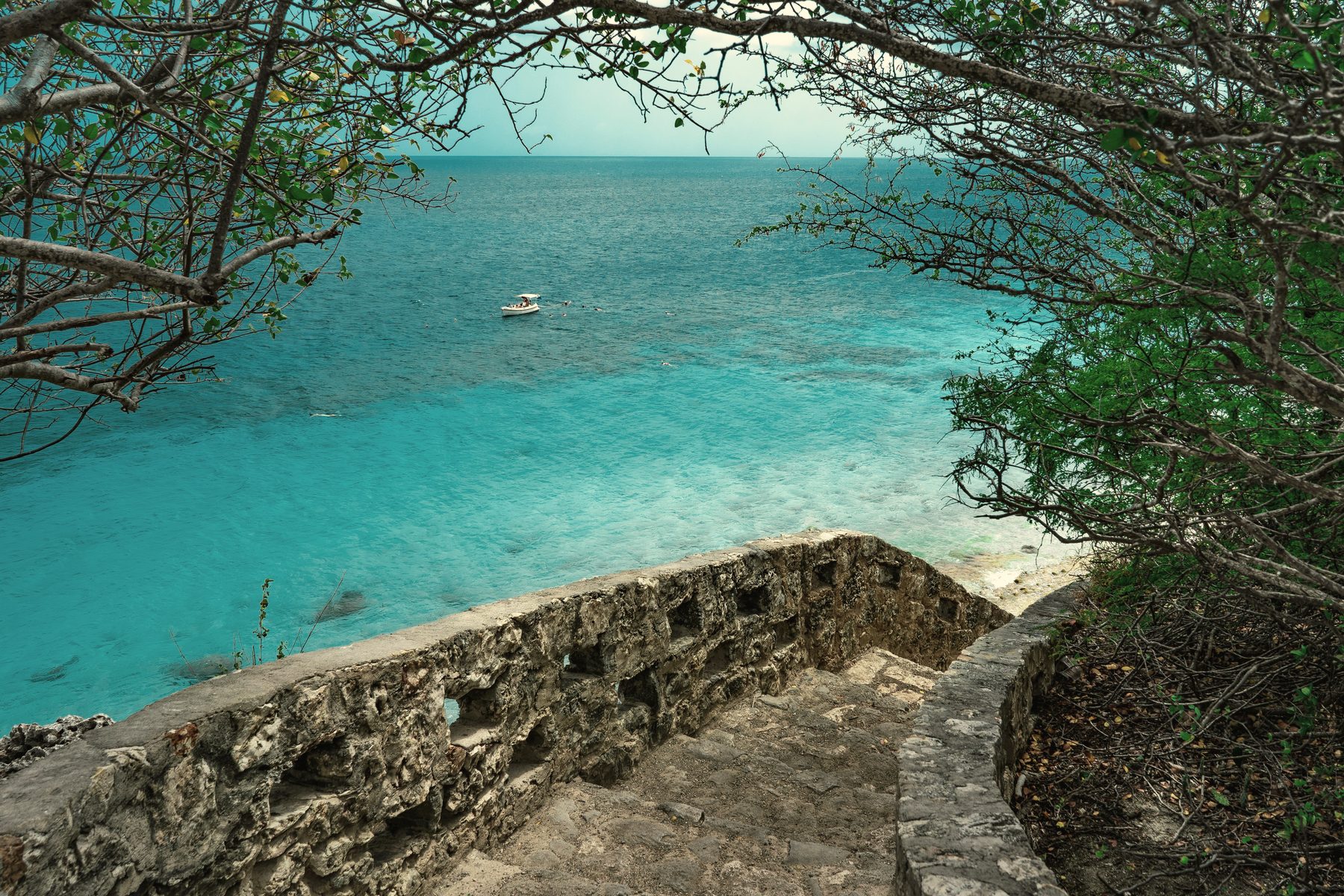Turquoise waters and stone stairway on Bonaire's coastline